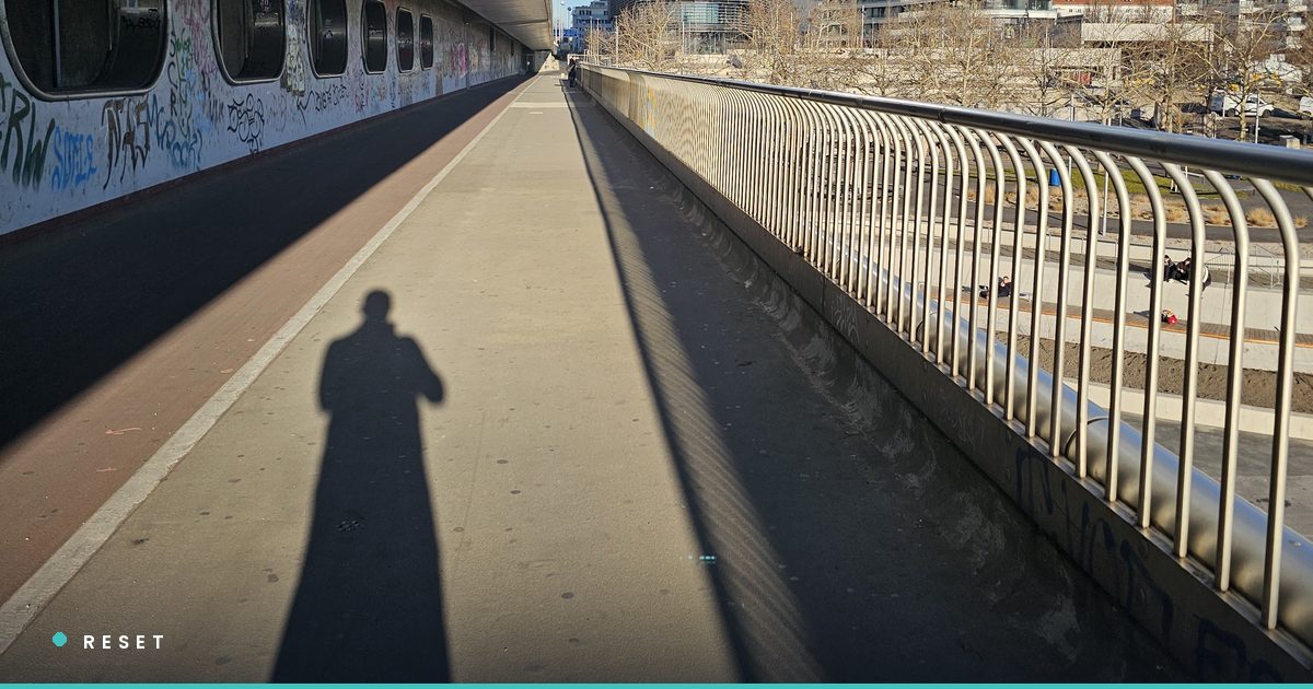 Chris Wilson on a bridge in Vienna, shadow casting on the pavement below