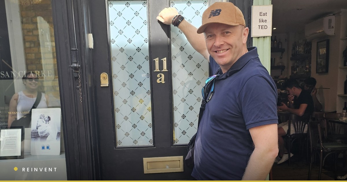 Chris Wilson knocking on the door of 11a in Richmond, the flat used as Ted Lasso's, beside a sign reading Eat like TED